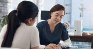 Woman receiving guidance about prenatal and postnatal care from a healthcare professional